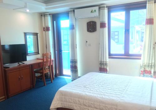 海防的住宿－Thien Anh Hotel，一间卧室配有一张床、一张书桌和一台电视