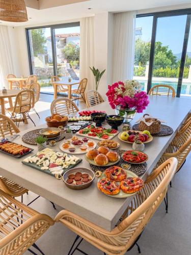 a table with a bunch of food on it at Carruba Boutique Hotel in Kas
