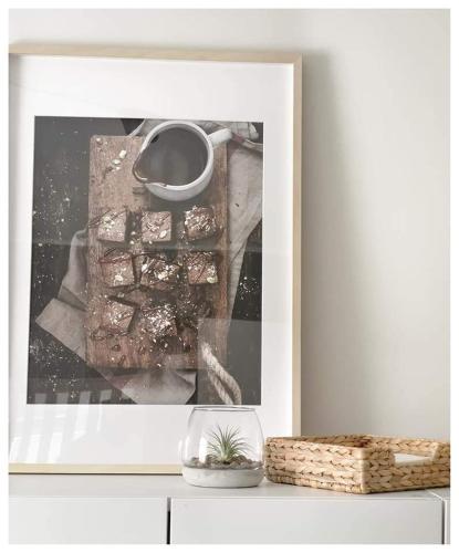 a framed picture of a pile of food on a shelf at Gallen-Kallelankatu 5 in Pori
