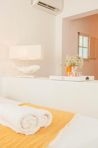 a bathroom with a towel on the floor and a mirror at 971 Hotel Con Encanto in Ciutadella