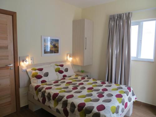 a bedroom with a bed with a polka dot blanket at Casa Inglesa in Salvador