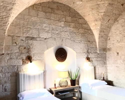 a room with a bed and a mirror at Masseria Morrone in Ostuni