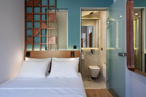 a bedroom with a bed and a bathroom at Camere Maritima in Chania Town