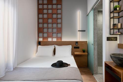 a bedroom with a bed with a hat on it at Camere Maritima in Chania Town