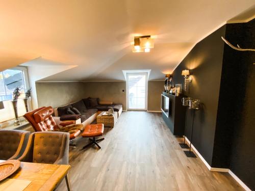 a living room with a couch and a table at Boutique Apartment Anne in Bad Harzburg