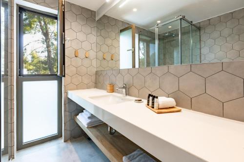 a bathroom with a large sink and a mirror at EOS Luxury Suites in Kriopigi