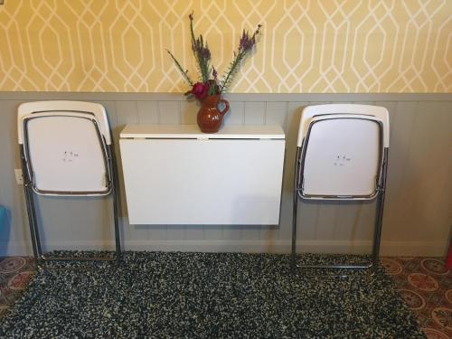 two white machines in a bathroom with a vase of flowers at PieNook in Blandford Forum