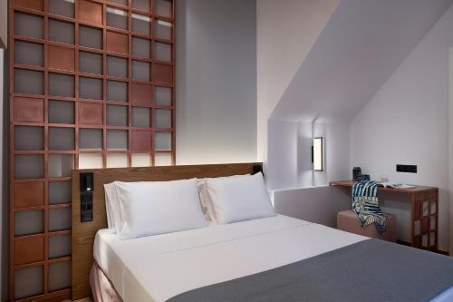 a bedroom with a bed and a wall of glass at Camere Maritima in Chania Town