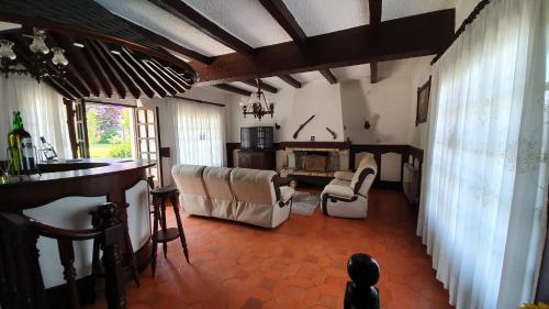 a living room with chairs and a bar in a room at Cargal leiria in Leiria
