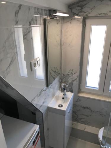 a bathroom with a sink and a mirror at Apartment Vid in Split