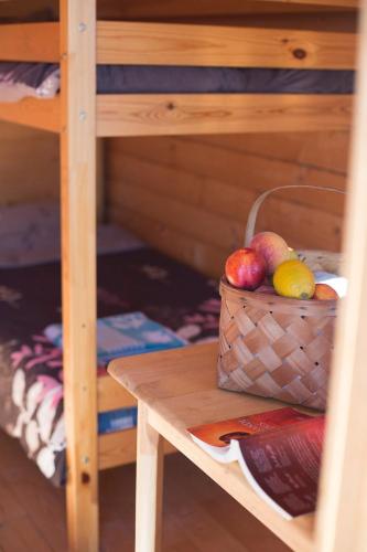 a basket of fruit on a table in a bunk bed at Paradise Beach Surf Bugalow Small in Kalana