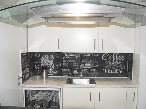 a kitchen with a chalkboard on the wall at Liège centre 6 rue montagne sainte Walburge, 4000 Liège, pour 2 pers à 3 minutes de la gare st Lambert in Liège