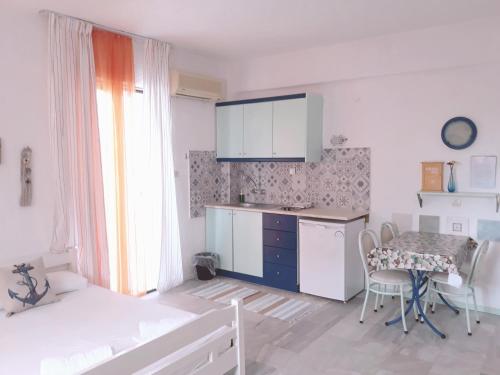 a small kitchen with a table and a table and chairs at Brunis Apartments in Nei Poroi
