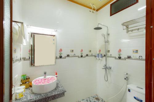 a bathroom with a sink and a shower at Tam Coc Lotus Flower Homestay in Ninh Binh
