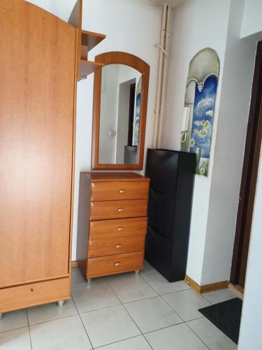 a bedroom with a dresser and a mirror at Apartament Gdańsk Wszędzie blisko , wysoki parter in Gdańsk