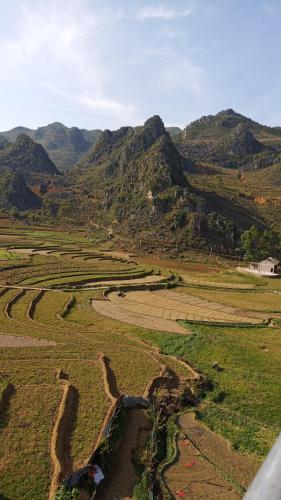 an aerial view of a field with mountains in the background at Hotel Cao Nguyên in Dồng Văn