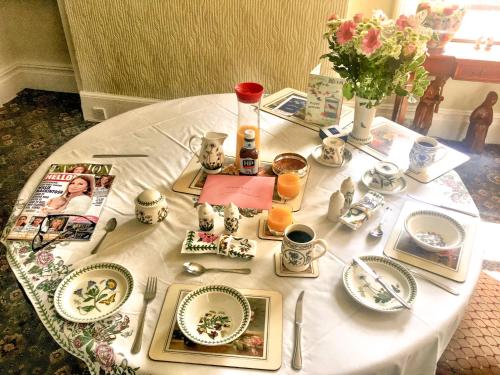 une table blanche avec des assiettes et des plats dessus dans l'établissement The Gaydon, à Lytham St Annes