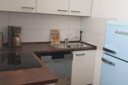 a small kitchen with a sink and a refrigerator at Ferienwohnung Charlotte Seebrise in Friedrichshafen