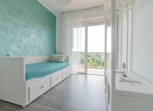 a white room with a bed and a window at La Terrazza in Castelletto sopra Ticino