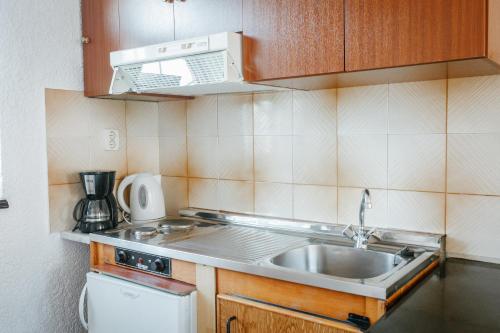 a small kitchen with a sink and a stove at Konaki Apartments in Maleme