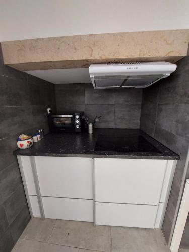 a kitchen with a counter top and a microwave at Aloha Hostel in Portimão