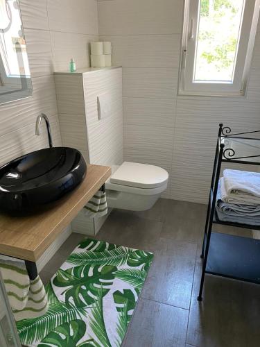 a bathroom with a sink and a toilet at Casa Fumica Studio in Kampor
