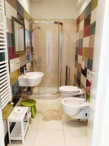 a bathroom with a sink and a toilet and a shower at Margherita Rimini - Appartamenti al Mare in Rimini