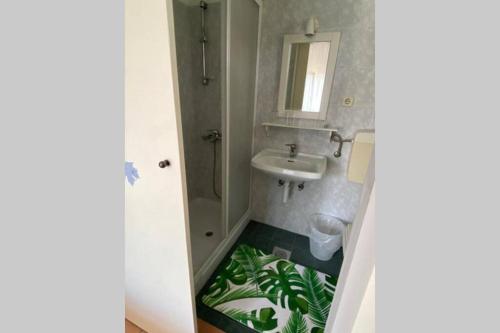 a bathroom with a sink and a toilet with a floor at Casa Fumica rooms in Rab