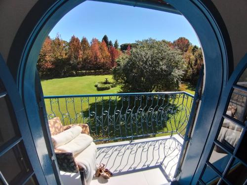 a room with a window with a view of a yard at Hotel Gramado Palace in Gramado