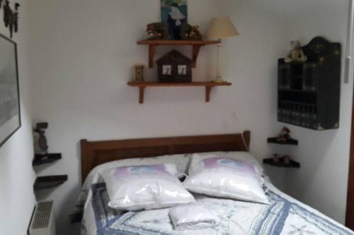 a bedroom with a bed with pillows on it at Appartement T3 Cosy St Gervais les Bains -Grattague in Mémontel