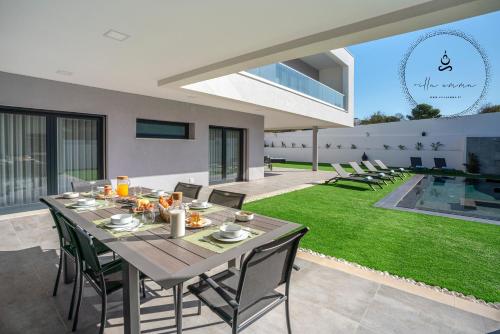 a dining area with a table and chairs in a house at V5 Villa Emma - Luxury 5 bedroom villa in Alvor with private Pool and Jacuzzi in Alvor