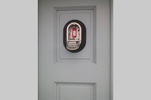 a white door with a red lock on it at Nikos & Efi Fabrica Residence in Megali Ammos