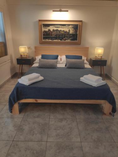 a bedroom with a large bed with two lamps on both sides at Can Blau in Roses