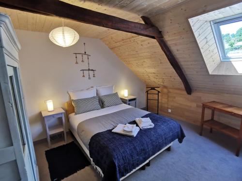 a bedroom with a large bed in a attic at Chez Yann et Valérie in Pont-Aven
