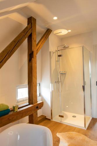 a bathroom with a shower and a white sink at VILLA zeitlos - PfauenAuge in Traunstein