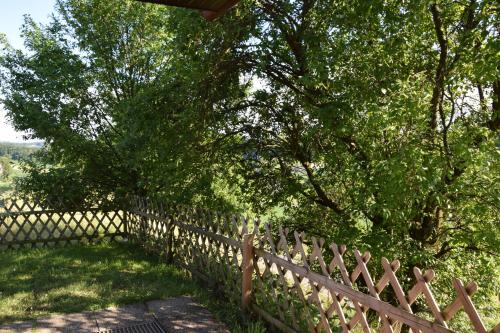 a wooden fence with trees in the background at Ferienhaus Jagafranzl in Gnas