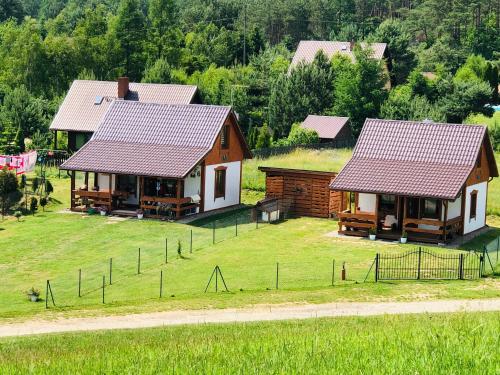an aerial view of two houses with a field and trees at Domki Eden Kaszuby balia sauna alpaki mini zoo in Gołubie