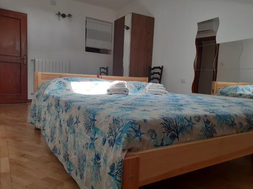 een slaapkamer met een bed met een blauw en wit dekbed bij Time Is You in Rapallo