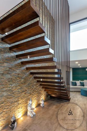 a staircase in a house with a brick wall at V5 Villa Emma - Luxury 5 bedroom villa in Alvor with private Pool and Jacuzzi in Alvor