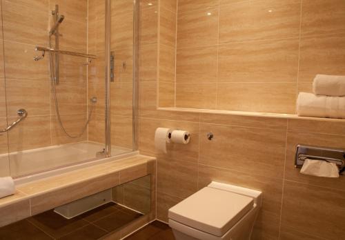 a bathroom with a shower and a toilet and a sink at Pontlands Park Hotel in Chelmsford