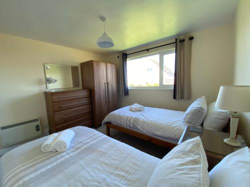 a hotel room with two beds and a window at Copthorne - Tintagel in Tintagel