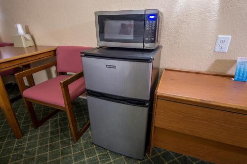 a microwave sitting on top of a refrigerator at Red River Inn Silt - Rifle in Silt
