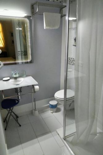 a bathroom with a shower and a sink and a toilet at Shoal Apartamentos in Playas de Orihuela