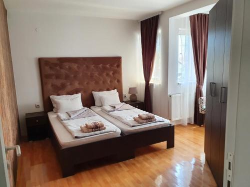 a bedroom with a bed with two donuts on it at Family Apartments in Zaječar