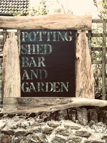 a sign that says running shed bar and garden at The Bridge House in Bridport