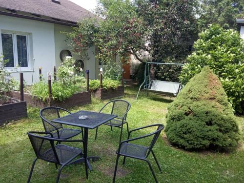 a table and chairs in the yard of a house at Pension Fontána Svitavy in Svitavy