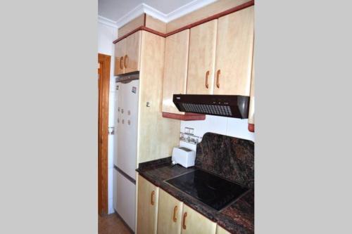 a kitchen with a stove and a refrigerator at APARTAMENTOS GALLACH (LA ERMITA) in Chulilla