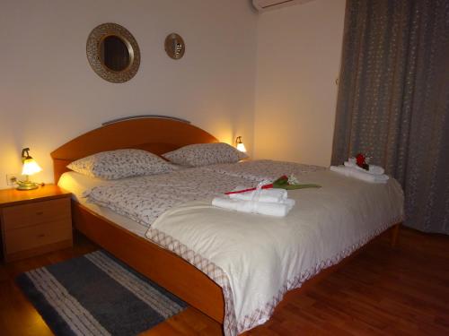 a bedroom with a bed with two towels on it at Rooms Kapelj in Postojna