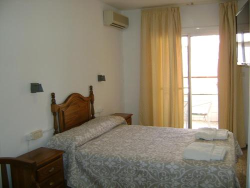 Cama o camas de una habitación en Hostal Residencia Pasaje