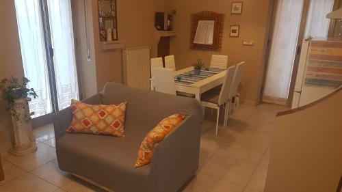a living room with a couch and a table at La casa del corso in Rodi Garganico